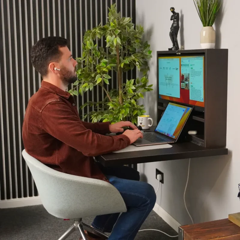 Man using a work from home desk with his laptop.