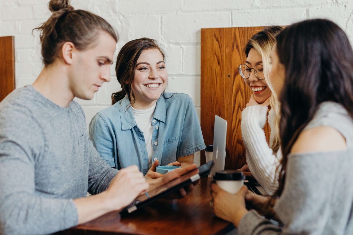 A team of people working on a project around a table.